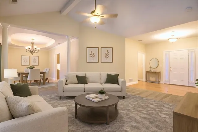 a living room with furniture and a chandelier