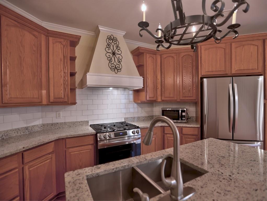 3221 Summer Stream Lane Kennesaw, GA 30152 - Photo 7 of 20 a kitchen with stainless steel appliances granite countertop a sink a stove and a refrigerator