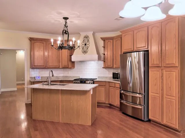 a kitchen with refrigerator a sink and cabinets
