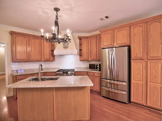 a view of a dining room with furniture wooden floor and chandelier