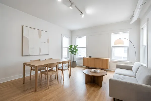 a living room with furniture a table and a potted plant