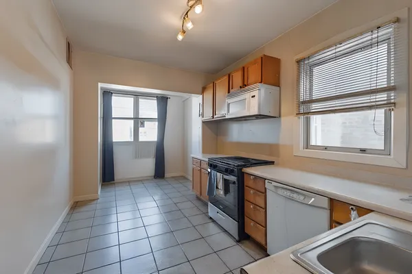 a kitchen with a stove a sink and a refrigerator
