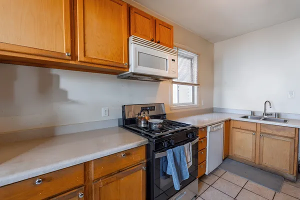 a kitchen with stainless steel appliances granite countertop a sink stove and cabinets