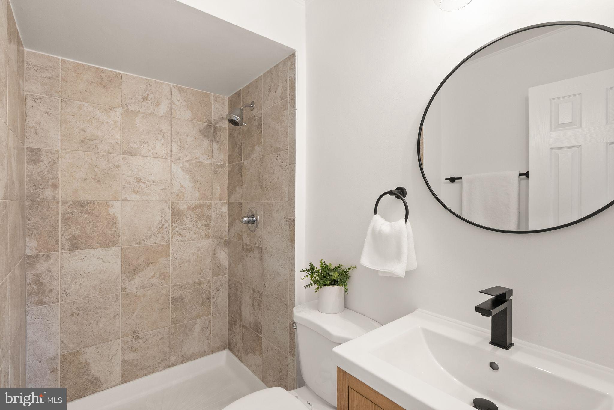 3203 Foothill Street Woodbridge, VA 22192 - Photo 30 of 57 a bathroom with a sink a toilet and a mirror