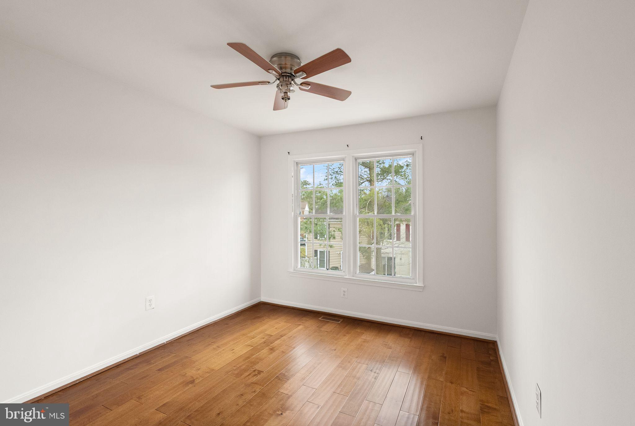 3203 Foothill Street Woodbridge, VA 22192 - Photo 36 of 57 an empty room with wooden floor fan and windows