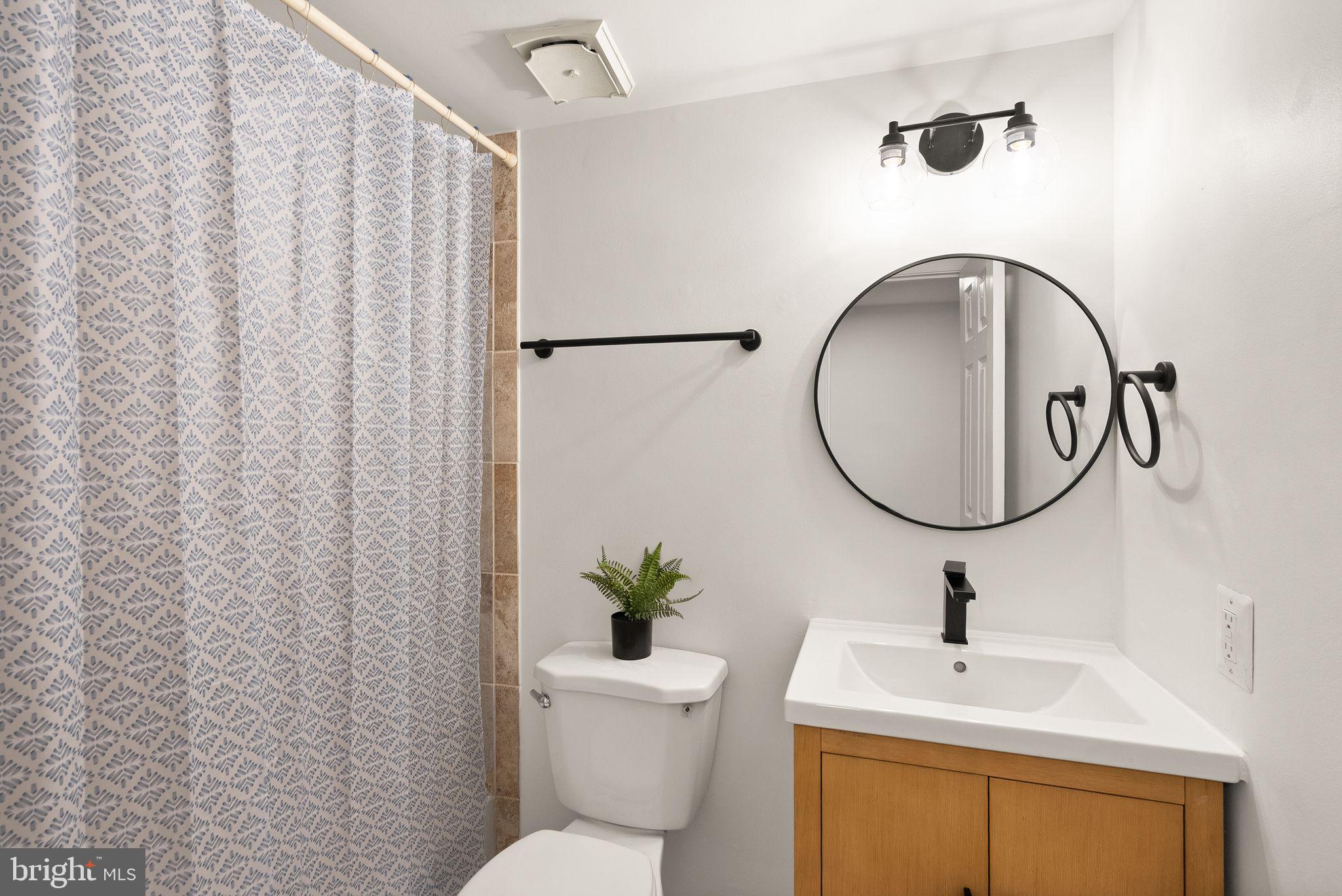 3203 Foothill Street Woodbridge, VA 22192 - Photo 39 of 57 a bathroom with a sink toilet and a mirror