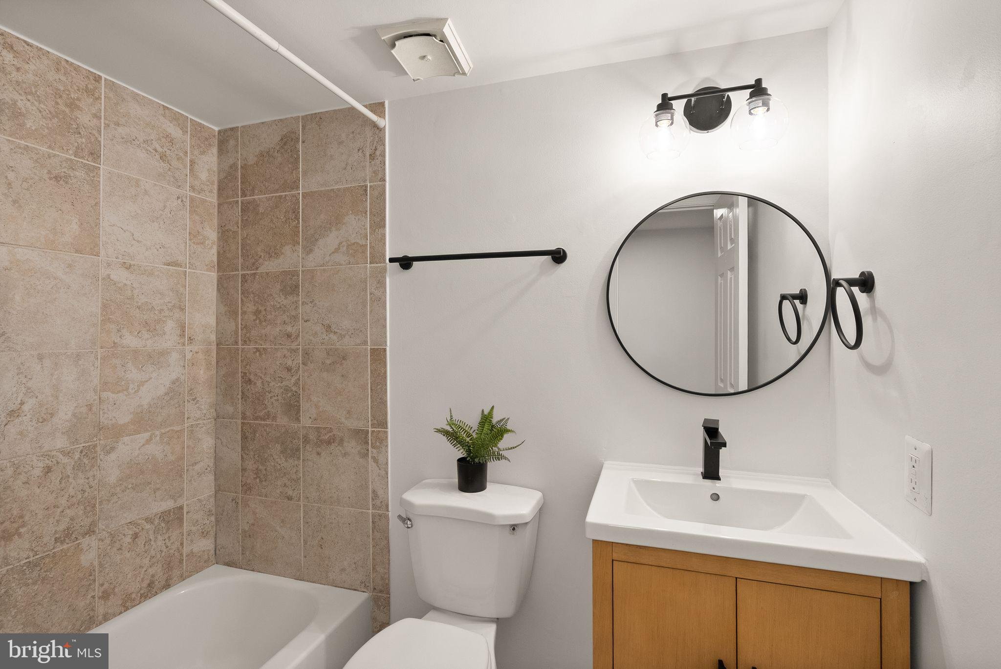 3203 Foothill Street Woodbridge, VA 22192 - Photo 40 of 57 a bathroom with a sink toilet and a mirror