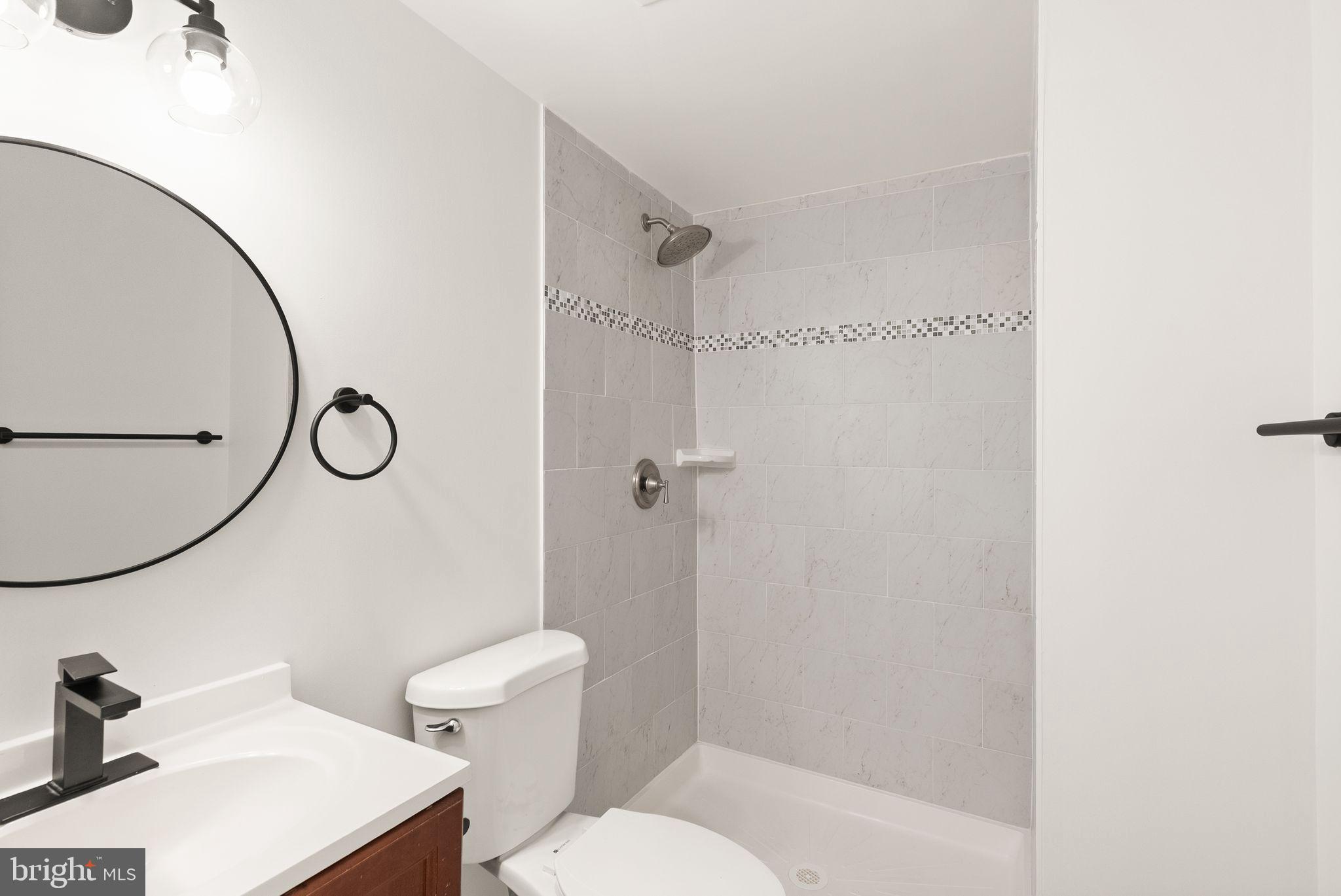 3203 Foothill Street Woodbridge, VA 22192 - Photo 48 of 57 a bathroom with a toilet a sink and a mirror