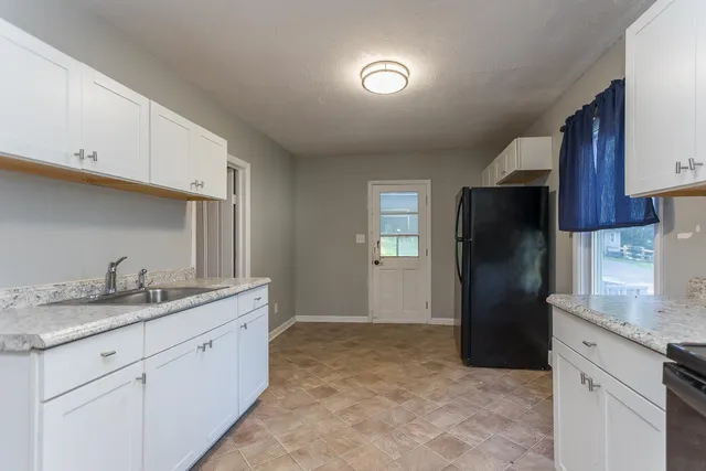 a kitchen with a sink and refrigerator