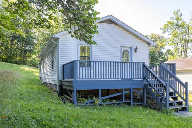 a view of a house with a yard and deck