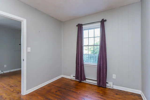 a view of a room with wooden floor