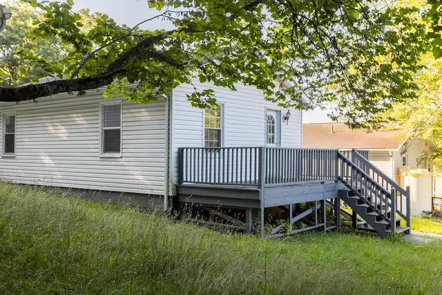 a view of a house with a yard and sitting area