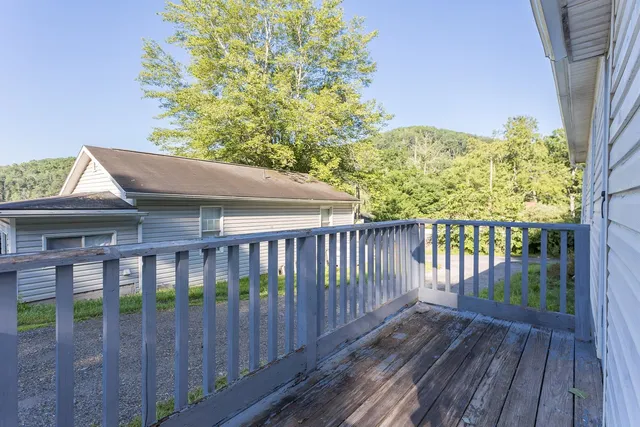 a view of a wooden fence and a yard