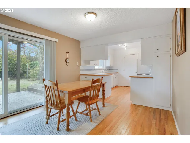a dining room with furniture and wooden floor