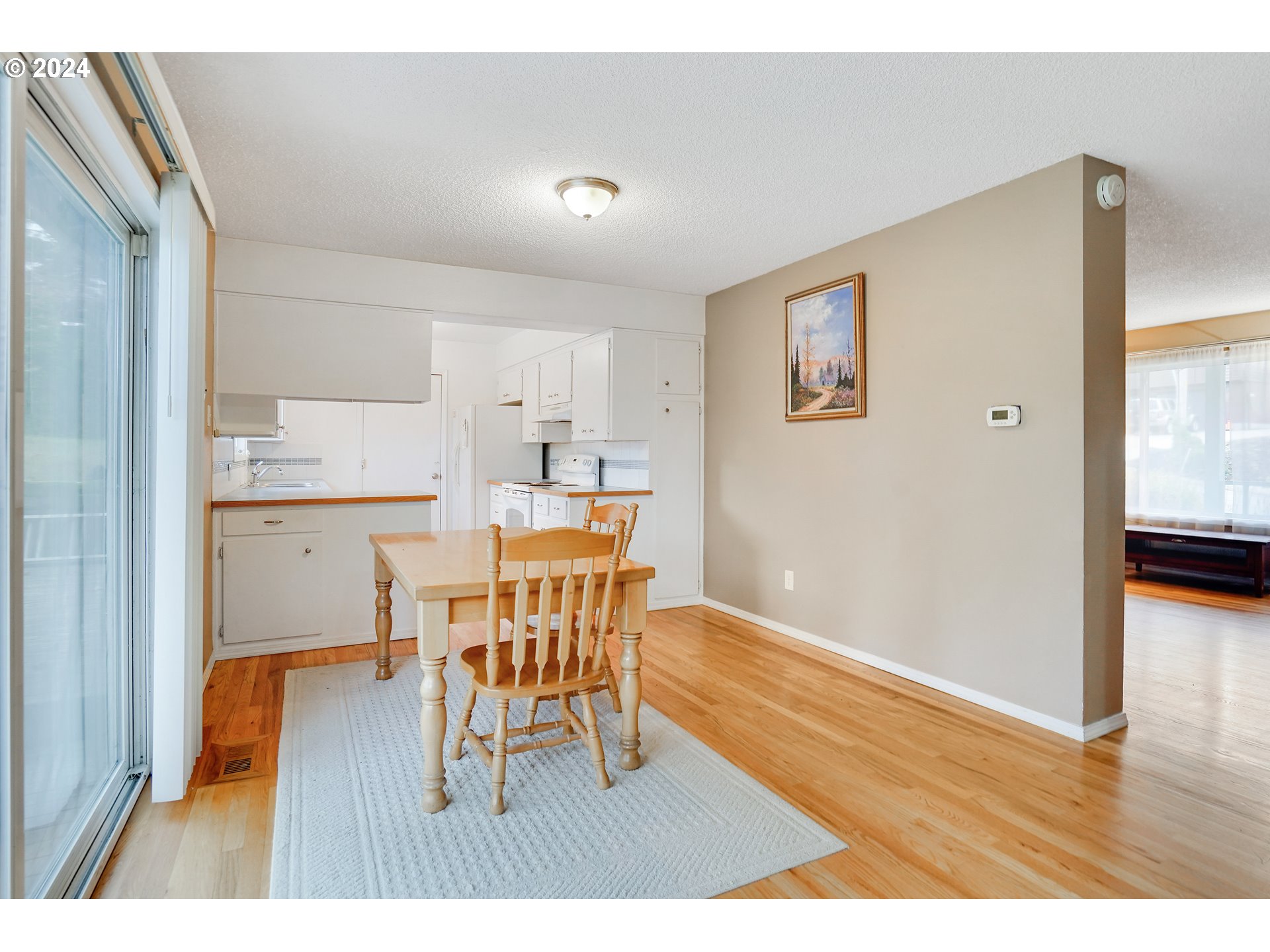390 Northwest Conifer Boulevard Corvallis, OR 97330 - Photo 12 of 47 a view of a dining room with furniture and wooden floor