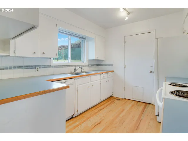 a kitchen with a sink cabinets and window