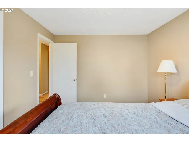 a bedroom with a bed and a night stand