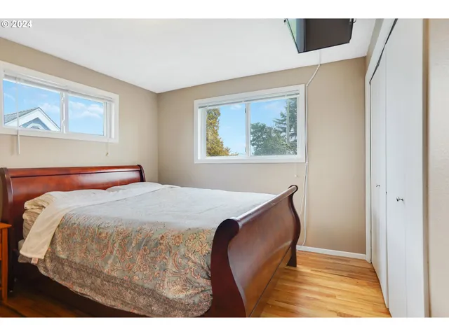 a bedroom with a bed and a painting on the wall