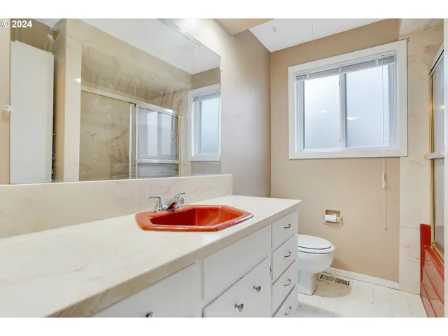 a bathroom with a sink toilet and mirror