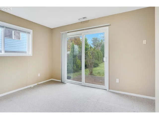 a view of an empty room with glass door