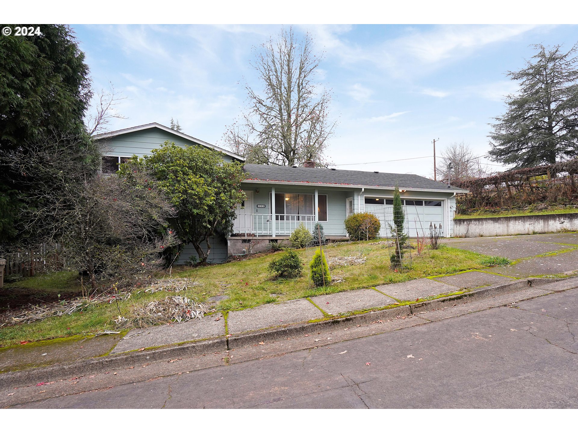 390 Northwest Conifer Boulevard Corvallis, OR 97330 - Photo 3 of 47 a view of house that has a small yard plants and large trees with wooden fence