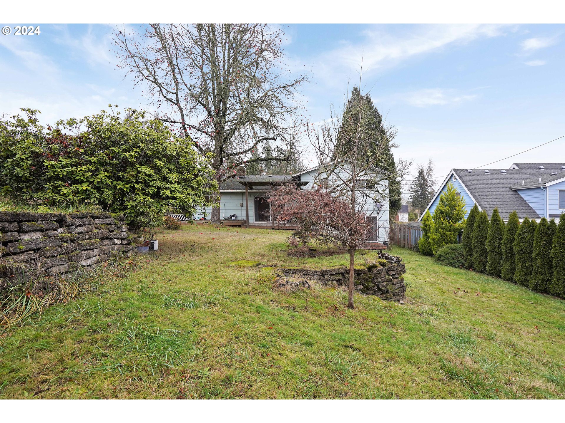 390 Northwest Conifer Boulevard Corvallis, OR 97330 - Photo 41 of 47 a backyard of a house with a garden and plants