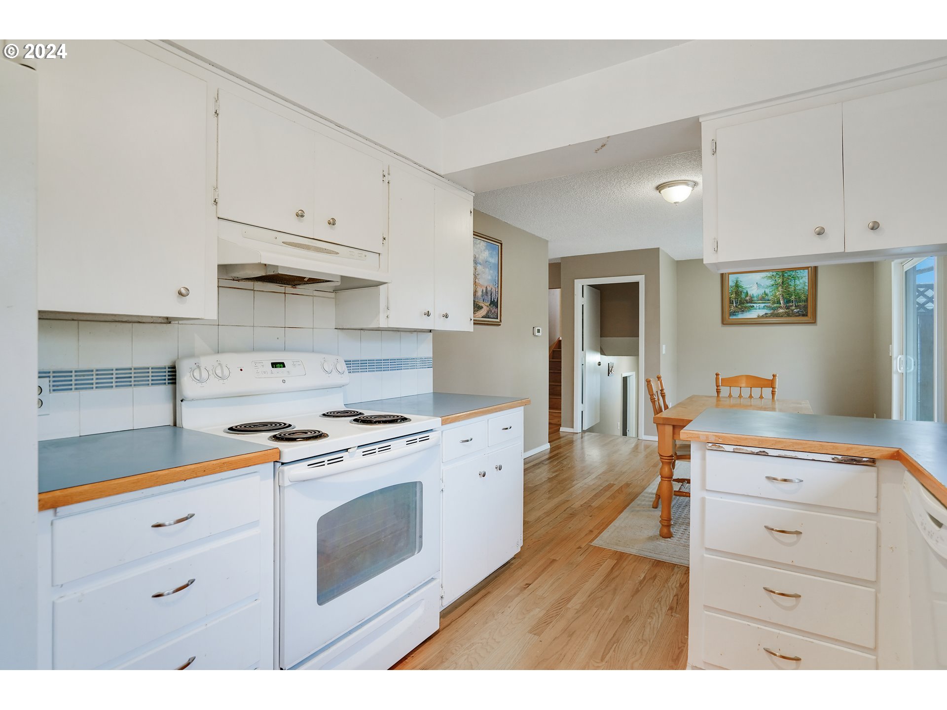 390 Northwest Conifer Boulevard Corvallis, OR 97330 - Photo 8 of 47 a kitchen with stainless steel appliances a stove a sink and white cabinets