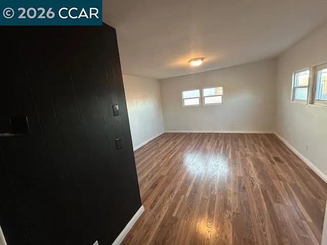 wooden floor in an empty room with a window