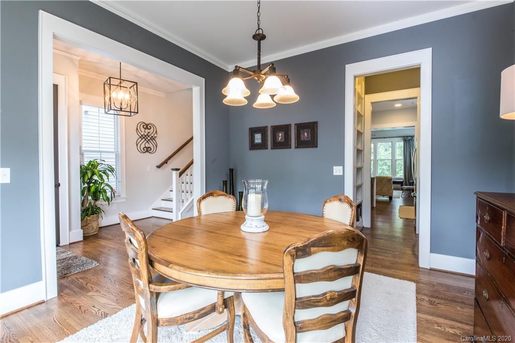 440 Hollyhock Lane Fort Mill, SC 29708 - Photo 10 of 28 a dining room with wooden floor a chandelier a wooden table and chairs