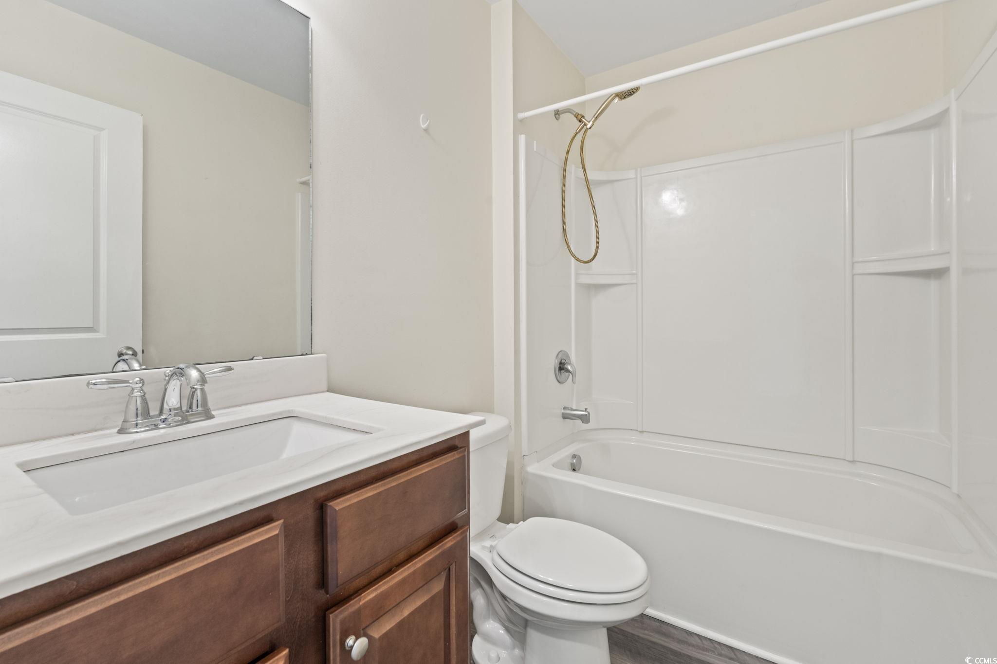3151 Holly Loop Conway, SC 29527 - Photo 21 of 31 Bathroom with vanity, washtub / shower combination, and wood finished floors