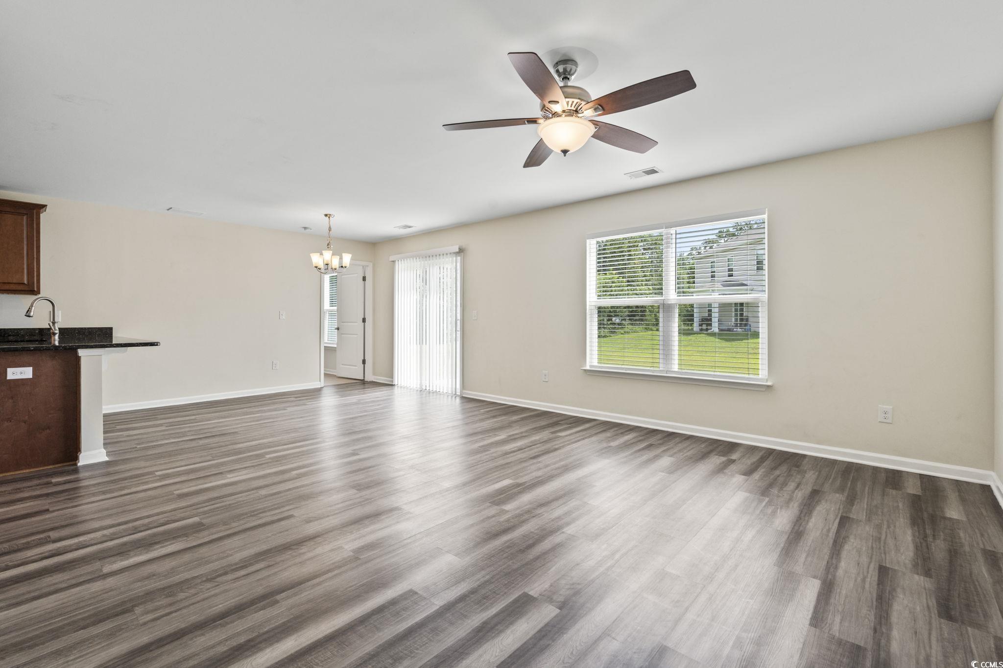 3151 Holly Loop Conway, SC 29527 - Photo 9 of 31 Unfurnished living room with a chandelier, dark wood-style flooring, and ceiling fan