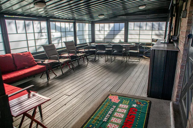 a living room with furniture a wooden floor and next to a window