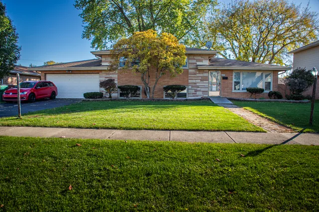 a front view of house with yard and outdoor seating