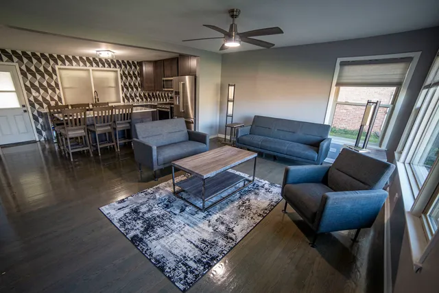 a living room with furniture and a chandelier