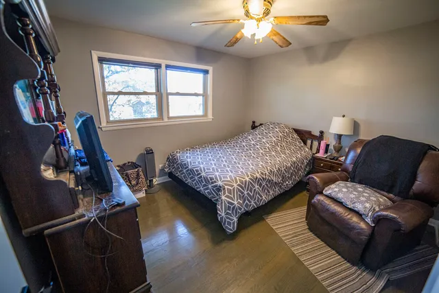 a bedroom with bed and a window