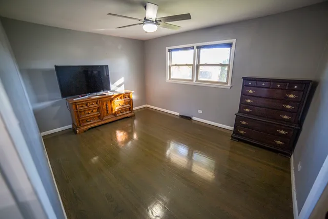 a view of a livingroom with furniture wooden floor and window