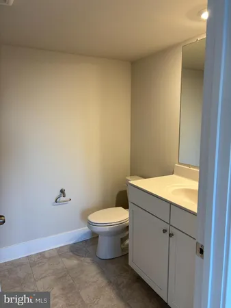 a white toilet sitting next to a bathroom sink
