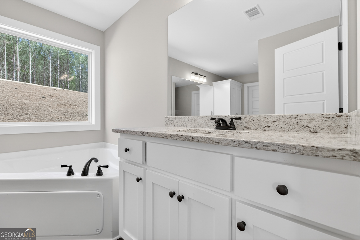 97 Wards Creek Road, Unit 1 Toccoa, GA 30577 - Photo 26 of 55 a bathroom with a granite countertop sink mirror and window