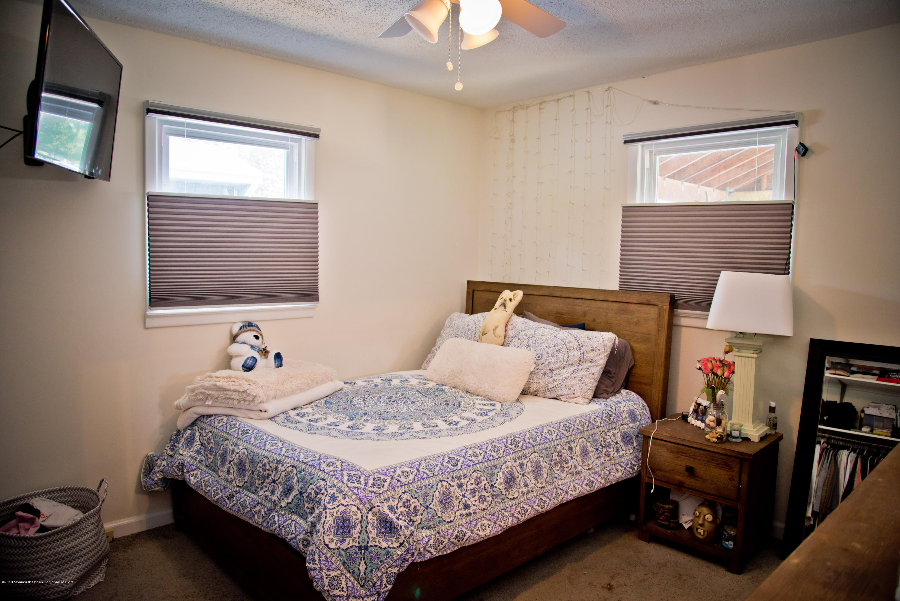 824 Beaver Dam Road Point Pleasant, NJ 08742 - Photo 17 of 35 a bedroom with a bed and a lamp on dresser