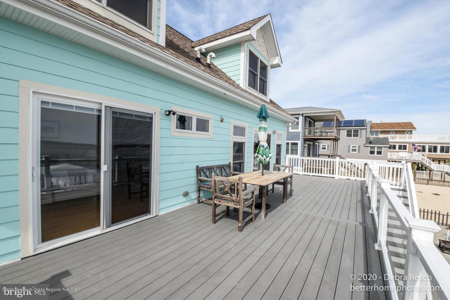 107 Parker Road Tuckerton, NJ 08087 - Photo 8 of 37 a balcony of a house with wooden floor outdoor seating and yard in the back