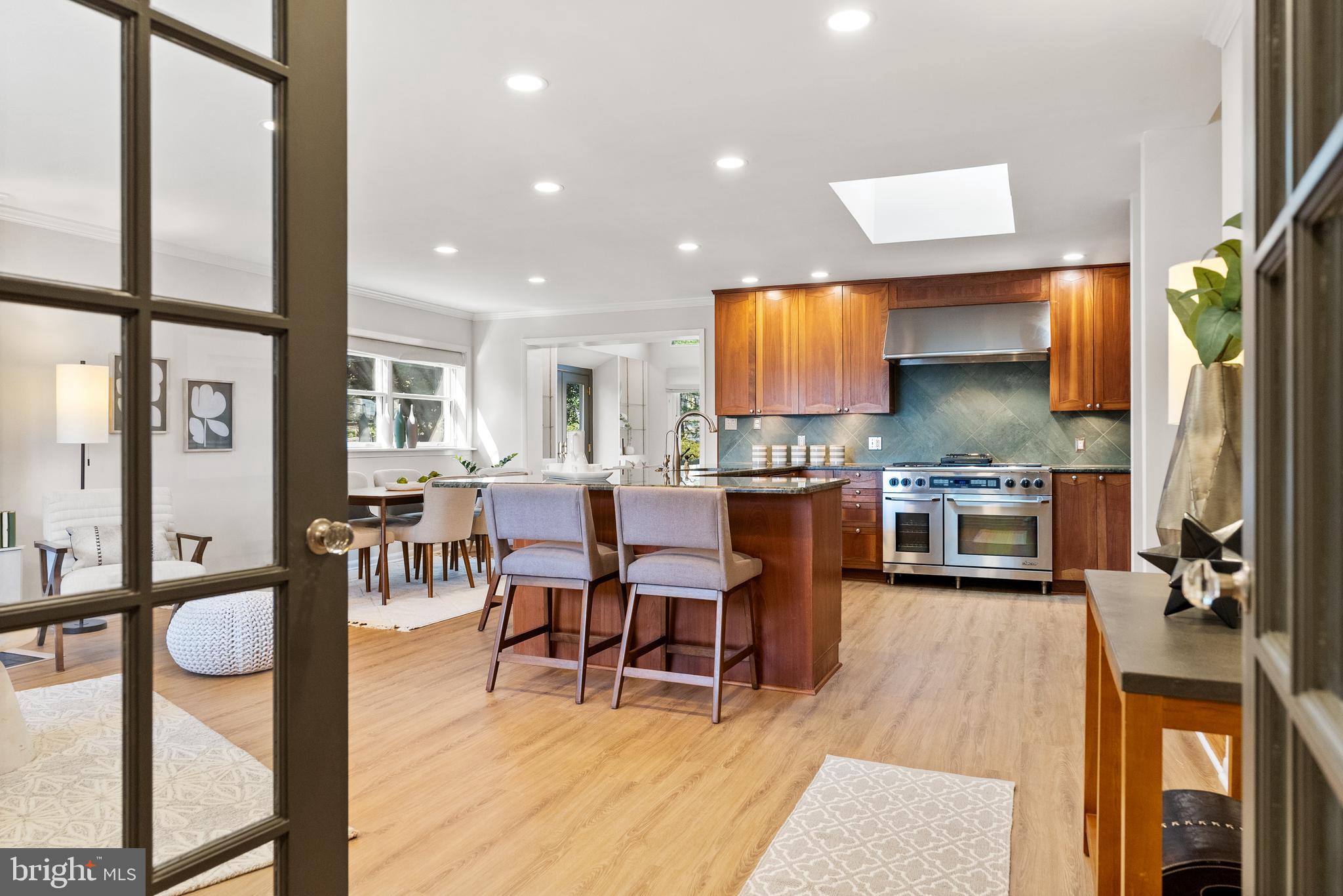 6417 Tone Drive Bethesda, MD 20817 - Photo 11 of 50 a open kitchen with stainless steel appliances granite countertop a refrigerator dining table and chairs