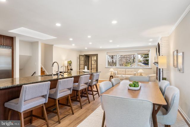 a view of a dining room with furniture and a potted plant