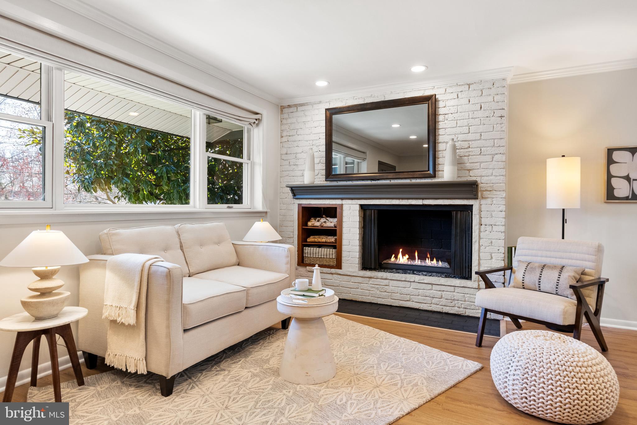 6417 Tone Drive Bethesda, MD 20817 - Photo 15 of 50 a living room with furniture a flat screen tv and a fireplace