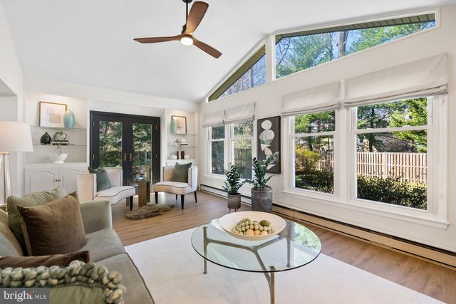 a living room with furniture and floor to ceiling windows