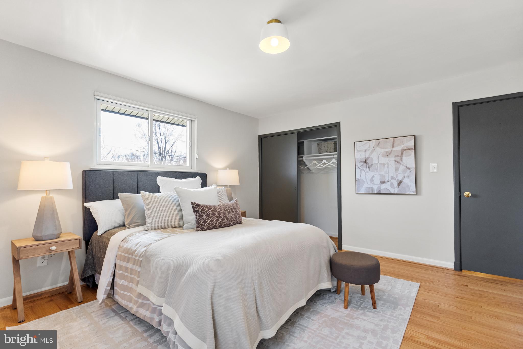 6417 Tone Drive Bethesda, MD 20817 - Photo 22 of 50 a bedroom with a bed and a lamp on table