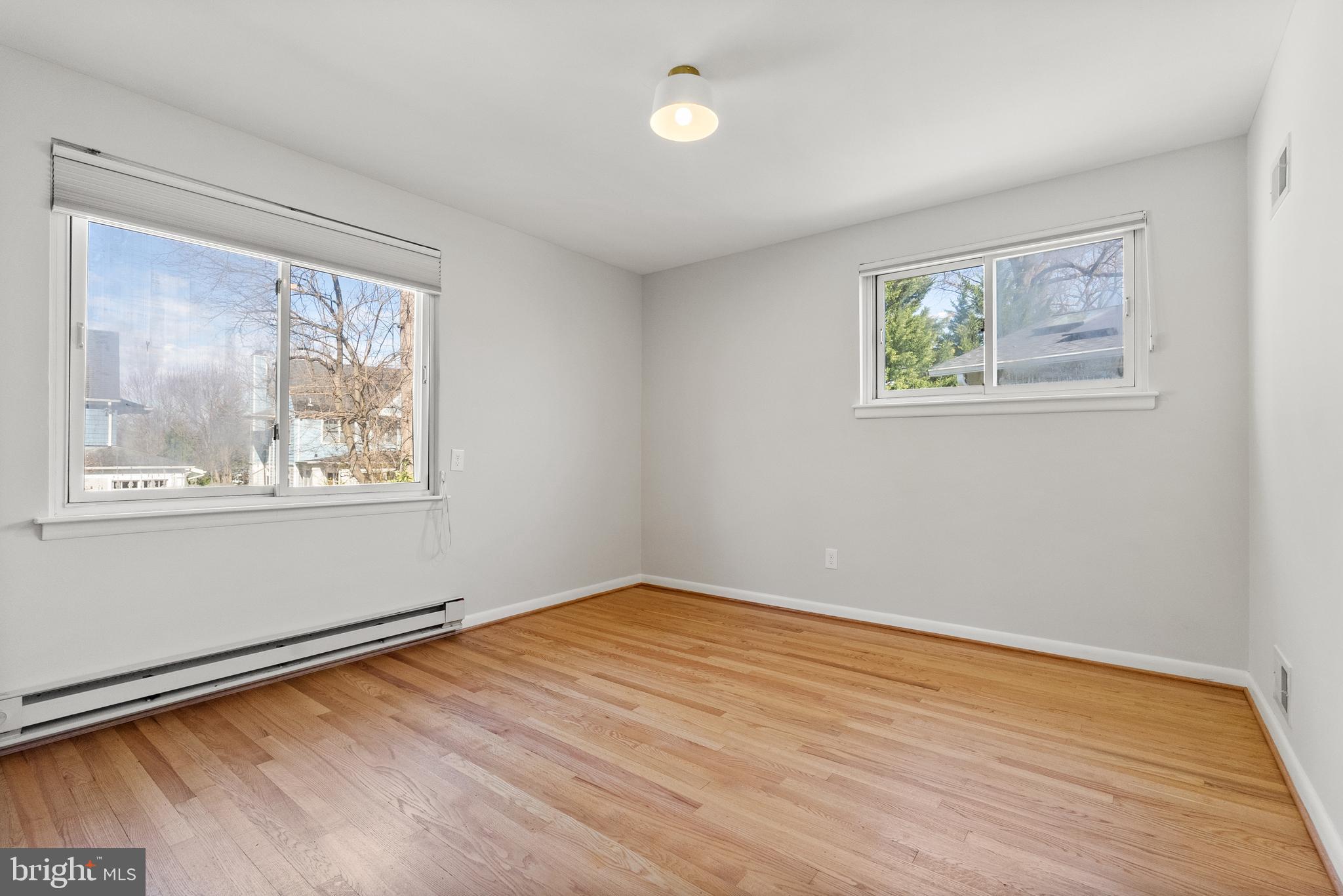 6417 Tone Drive Bethesda, MD 20817 - Photo 26 of 50 a view of empty room with window and wooden floor