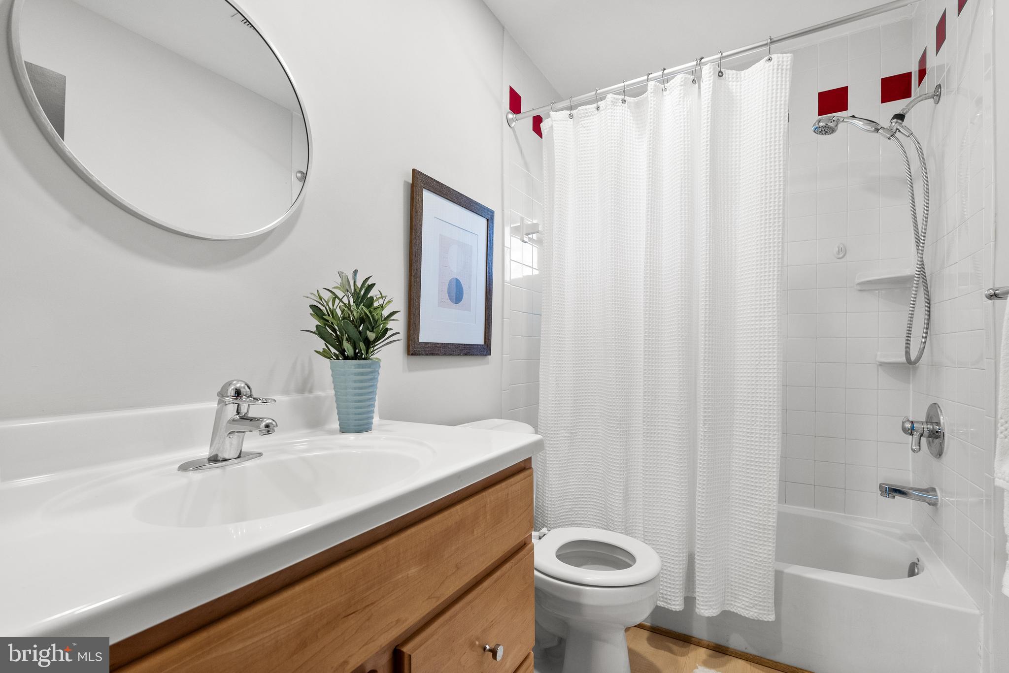 6417 Tone Drive Bethesda, MD 20817 - Photo 28 of 50 a bathroom with a sink toilet and shower