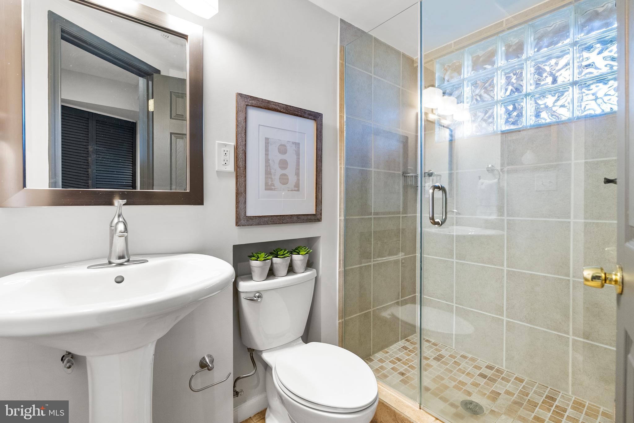 6417 Tone Drive Bethesda, MD 20817 - Photo 32 of 50 a bathroom with a sink a toilet and shower