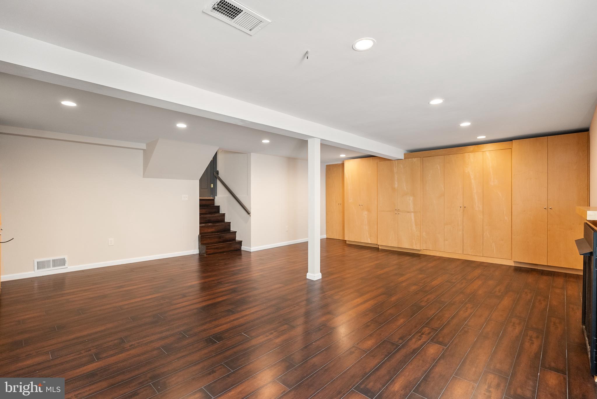 6417 Tone Drive Bethesda, MD 20817 - Photo 38 of 50 a view of an empty room with wooden floor and stairs