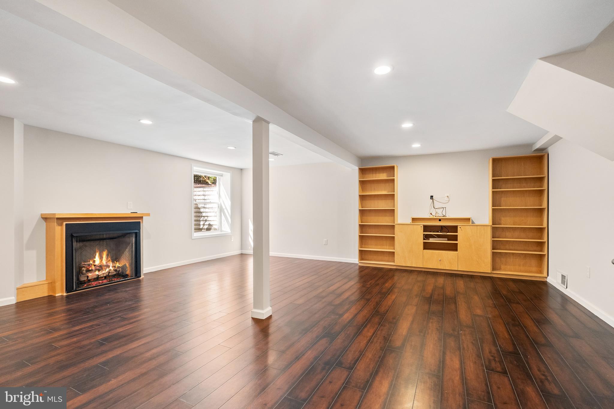 6417 Tone Drive Bethesda, MD 20817 - Photo 41 of 50 a view of an empty room with wooden floor fireplace and a window